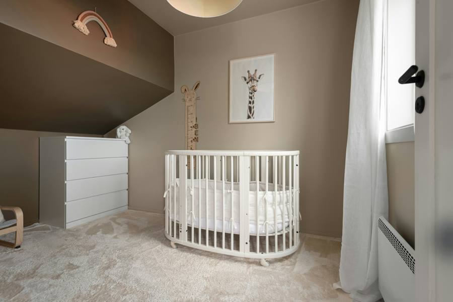 A calm nursery with a white crib