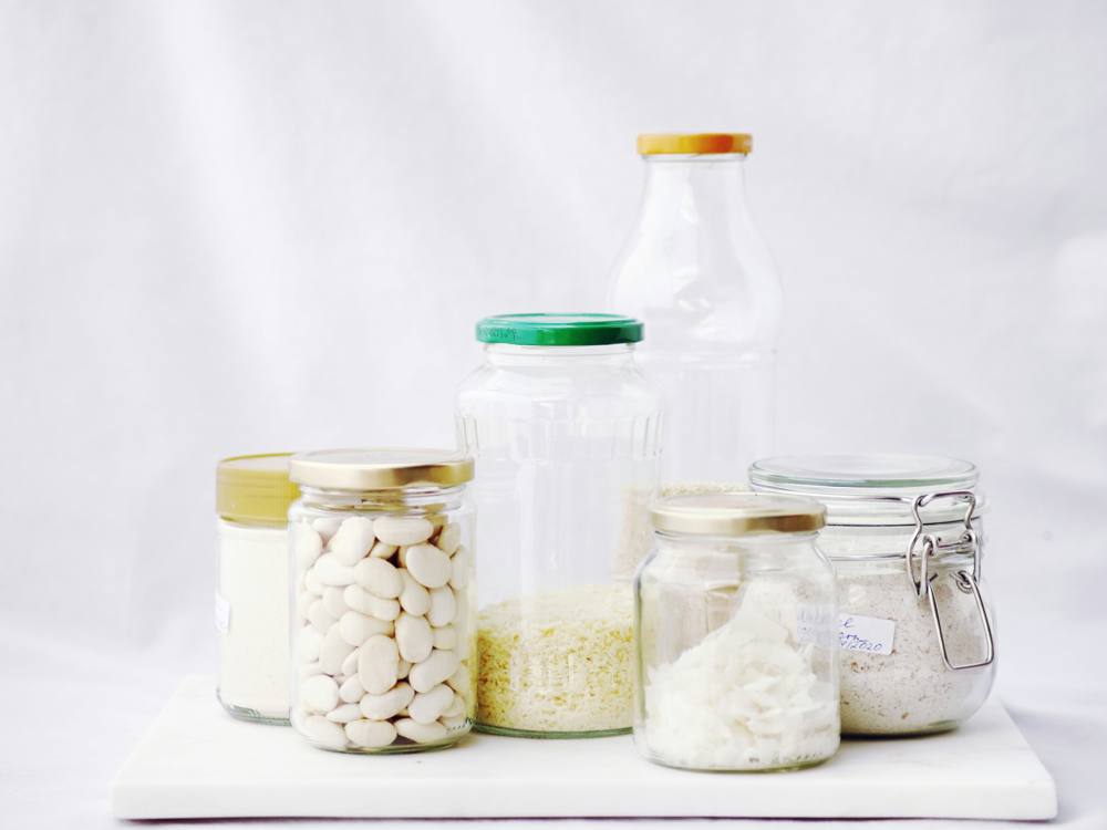 Glass jars filled with beans, rice, and coconut flakes